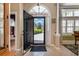 Welcoming foyer with arched doorway, neutral tile flooring, and a view to the landscaped front yard at 1004 Addington Ct., Murrells Inlet, SC 29576