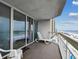 Oceanfront balcony with seating and views of the beach and pool at 1012 N Waccamaw Dr. # 301, Garden City Beach, SC 29576