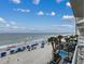 Stunning ocean view highlighting clear blue waters, sandy beach, and nearby resorts at 1012 N Waccamaw Dr. # 301, Garden City Beach, SC 29576