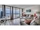 Cozy living room features ocean view, comfortable seating and access to private balcony at 1012 N Waccamaw Dr. # 301, Garden City Beach, SC 29576