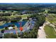 Aerial view of condos by golf course with parking and community pool with a pond at 1041 True Blue Dr. # 37A, Pawleys Island, SC 29585