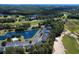 Aerial view of condos by golf course with parking and community pool with a pond at 1041 True Blue Dr. # 37A, Pawleys Island, SC 29585