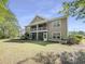 Lush backyard view showcases the condo's rear exterior with covered patios and ample lawn space at 1041 True Blue Dr. # 37A, Pawleys Island, SC 29585