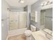 Bathroom featuring a shower and tub combination with sliding glass doors, toilet, and a sink with chrome fixtures at 1041 True Blue Dr. # 37A, Pawleys Island, SC 29585