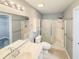 Bathroom featuring a shower with sliding glass doors, a toilet, and sink with chrome fixtures at 1041 True Blue Dr. # 37A, Pawleys Island, SC 29585