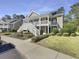 Attractive condo featuring a welcoming double staircase leading to the upper levels with green shutters and landscaped walkway at 1041 True Blue Dr. # 37A, Pawleys Island, SC 29585