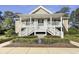 Charming condo featuring a double staircase leading to inviting upper-level entrances, complemented by landscaped greenery at 1041 True Blue Dr. # 37A, Pawleys Island, SC 29585