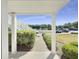 Inviting covered front porch with white columns and walkway with a view of parking and pond at 1041 True Blue Dr. # 37A, Pawleys Island, SC 29585