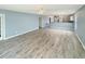 Open-concept living area features light gray flooring, a ceiling fan, and a view into the kitchen at 1041 True Blue Dr. # 37A, Pawleys Island, SC 29585