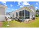 View of backyard with lawn, hardscape and landscaping connecting to the sunroom at 1048 Longwood Bluffs Circle, Murrells Inlet, SC 29576