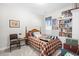 Cozy bedroom with patterned bedspread, framed artwork, and built-in bookcase at 1048 Longwood Bluffs Circle, Murrells Inlet, SC 29576