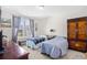 Bright bedroom with two twin beds, large windows with blue curtains, and wood furniture at 1048 Longwood Bluffs Circle, Murrells Inlet, SC 29576