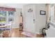 Inviting entryway showcasing hardwood floors, decorative door, and natural light from the adjacent dining area at 1048 Longwood Bluffs Circle, Murrells Inlet, SC 29576