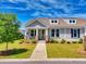 Charming home with a well-manicured front yard and inviting entrance with beautiful columns and landscaping at 1048 Longwood Bluffs Circle, Murrells Inlet, SC 29576