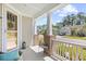 Inviting front porch with decorative columns and space for seating; view of the neighborhood at 1048 Longwood Bluffs Circle, Murrells Inlet, SC 29576