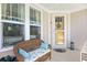 Charming front porch with a wicker bench, decorative pillows, and an inviting entrance at 1048 Longwood Bluffs Circle, Murrells Inlet, SC 29576