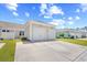 Detached two-car garage with a wide driveway and manicured lawn in a residential neighborhood at 1048 Longwood Bluffs Circle, Murrells Inlet, SC 29576