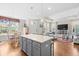 Open-concept kitchen flows to a living area with a central island and modern pendant lighting at 1048 Longwood Bluffs Circle, Murrells Inlet, SC 29576