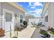 Outdoor patio area with seating, barbecue grill, privacy fence and various potted plants at 1048 Longwood Bluffs Circle, Murrells Inlet, SC 29576