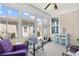 Cozy sunroom with bright windows, ceiling fan, and an outdoor view; includes a table and chairs at 1048 Longwood Bluffs Circle, Murrells Inlet, SC 29576