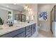 Bathroom features double vanity, modern lighting, glass enclosed shower, and neutral paint at 1061 Edenton Dr., Calabash, NC 28467