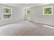 Spacious bedroom bathed in natural light from multiple windows, carpeted flooring, and neutral walls at 1061 Edenton Dr., Calabash, NC 28467