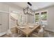 Dining room with modern light fixture and views, set for an elegant dinner at 1061 Edenton Dr., Calabash, NC 28467
