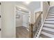 Inviting foyer featuring elegant wood flooring and a staircase with iron railings at 1061 Edenton Dr., Calabash, NC 28467