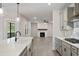 Open kitchen with stainless hood, and views to the living room and back deck at 1061 Edenton Dr., Calabash, NC 28467