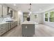Bright kitchen with an island, stainless steel appliances, gray cabinetry, and modern pendant lighting at 1061 Edenton Dr., Calabash, NC 28467
