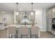 Open concept kitchen featuring center island, seating, and views into the adjacent living room at 1061 Edenton Dr., Calabash, NC 28467