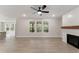 Bright living room featuring light wood floors, fireplace, and backyard view at 1061 Edenton Dr., Calabash, NC 28467