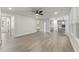 Spacious living room featuring light wood floors, ceiling fan, and open access to the modern kitchen at 1061 Edenton Dr., Calabash, NC 28467