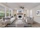 Cozy living room with modern decor, fireplace, ample seating, and backyard views at 1061 Edenton Dr., Calabash, NC 28467