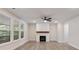 Bright living room boasts large windows, modern fireplace, and ceiling fan at 1061 Edenton Dr., Calabash, NC 28467