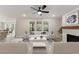Bright living room featuring light wood floors, fireplace, and backyard view; staged furniture at 1061 Edenton Dr., Calabash, NC 28467
