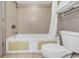 Compact bathroom featuring a shower-tub combo with neutral tiling and essential fixtures at 107 S Ocean Blvd. # 1001, Myrtle Beach, SC 29577
