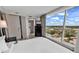 Comfortable bedroom featuring large windows with views, TV, and access to the adjacent bathroom at 107 S Ocean Blvd. # 1001, Myrtle Beach, SC 29577
