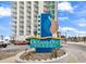 Oceans One Resort's prominent signage in front of the high-rise building and palm tree landscaping at 107 S Ocean Blvd. # 1001, Myrtle Beach, SC 29577