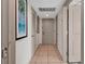 Hallway with neutral walls, a tiled floor, and beach themed artwork at 107 S Ocean Blvd. # 1001, Myrtle Beach, SC 29577