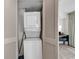 A laundry closet featuring a stacked washer and dryer unit at 107 S Ocean Blvd. # 1001, Myrtle Beach, SC 29577