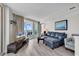 Comfortable living room with TV, balcony access and scenic views at 107 S Ocean Blvd. # 1001, Myrtle Beach, SC 29577