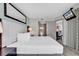 Well-lit main bedroom featuring bathroom access and ceiling mounted TV at 107 S Ocean Blvd. # 1001, Myrtle Beach, SC 29577