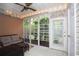 A screened porch with tile floors and cozy furniture at 109 Old Town Way # 4, Myrtle Beach, SC 29588