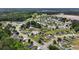 A sprawling neighborhood with lush greenery, a pond, and diverse homes, surrounded by trees and open fields at 1108 Blue Juniper Ct., Conway, SC 29527