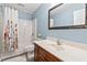Traditional bathroom featuring a shower-tub combo and vanity with a decorative mirror at 1108 Blue Juniper Ct., Conway, SC 29527