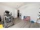 A clean, utilitarian bedroom space with workout equipment and gray wood-look flooring at 1108 Blue Juniper Ct., Conway, SC 29527
