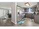 View of the kitchen and living room with gray cabinets and stainless fridge at 1108 Blue Juniper Ct., Conway, SC 29527