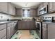 Charming kitchen features gray cabinets, stainless appliances, and hardwood floors at 1108 Blue Juniper Ct., Conway, SC 29527