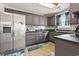 Neutral kitchen includes stainless steel refrigerator, dishwasher, and gray cabinets at 1108 Blue Juniper Ct., Conway, SC 29527